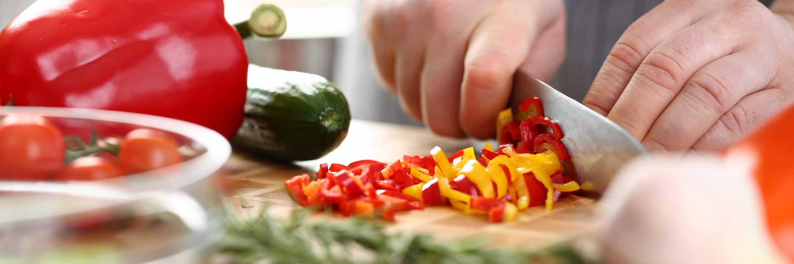 close up of chef slicing vegetables
